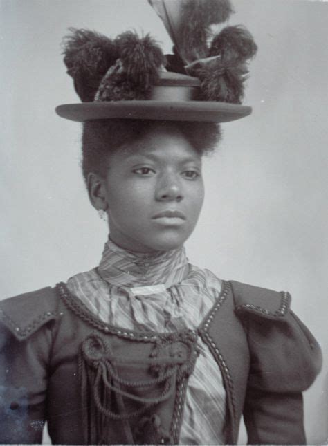An Old Black And White Photo Of A Woman Wearing A Hat With Feathers On It