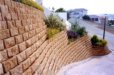 Rather than messing around with mortar, they lay the walls down like lego pieces, using concrete while it's still in the bag. L16 Retaining Wall Block - The Blockmakers