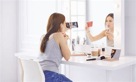 Amazing Young Woman Doing Her Makeup In Front Of Mirror Portrait Of