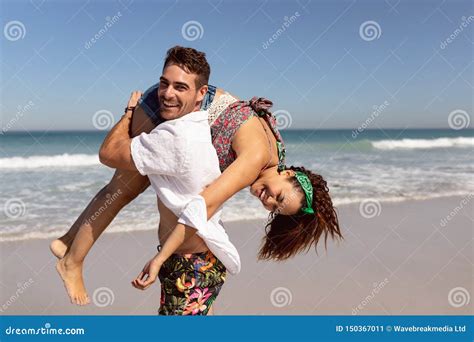 Man Carrying Woman On Shoulders On Beach In The Sunshine Stock Image Image Of Activity Camera