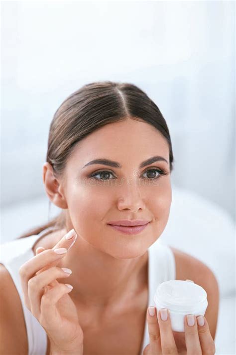Beauty Beautiful Woman Applying Face Cream On Soft Facial Skin Stock Photo Image Of