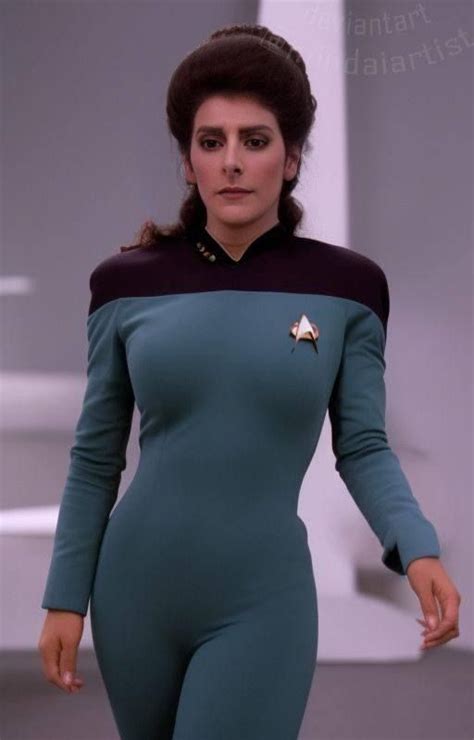 A Woman In A Star Trek Costume Walks Down The Runway With Her Hand On