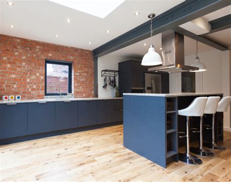 Industrial Kitchen With Exposed Brick And Stainless Steel Features