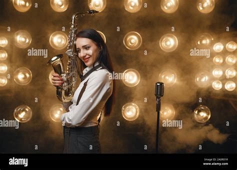 Female Saxophonist Poses With Saxophone On Stage Stock Photo Alamy