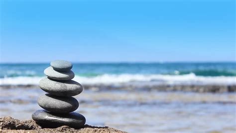 Stones Pyramid On The Beach Ocean In The Background Stock Footage