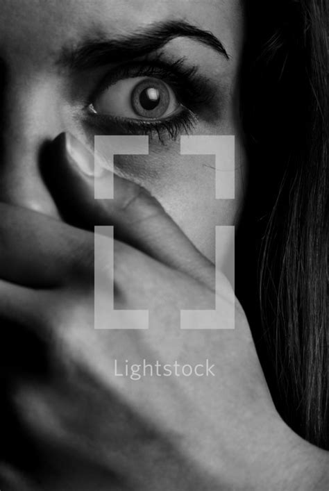 A Woman With Her Hand Over Her Mouth — Photo — Lightstock