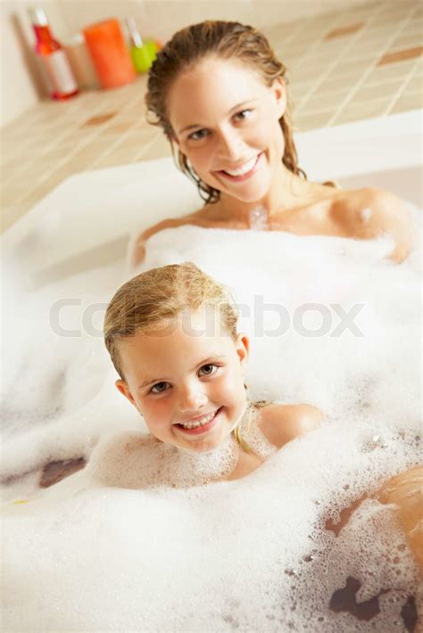 Mother And Daughter Relaxing In Bubble Filled Bath Stock Image Colourbox