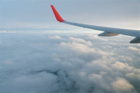 Wing Of Airplane Flying Over Clouds · Free Stock Photo