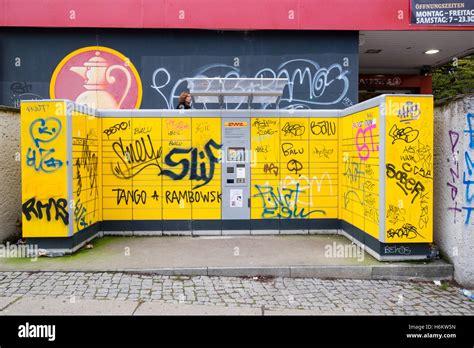 DHL self service parcel drop off lockers covered in graffiti in Stock