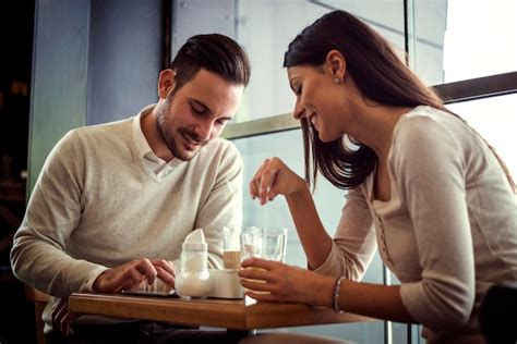 Premium Photo Couple Drinking Coffee And Chatting In Cafe