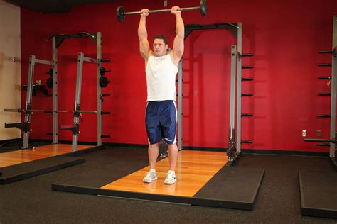 Standing Front Barbell Raise Over Head Exercise Guide And Video