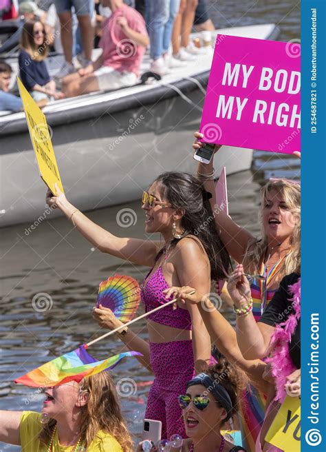 holding a billboard on the amnesty international boat on the at the gaypride canal parade with