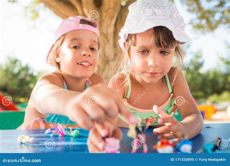 Two Little Cute Girls Playing Dolls Outdoors Stock Image Image Of