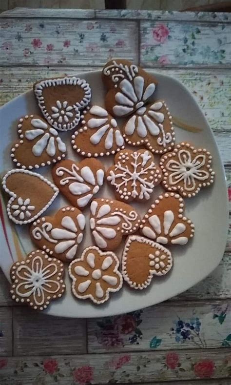 Some Cookies Are On A White Plate With Pink Flowers And Hearts In The