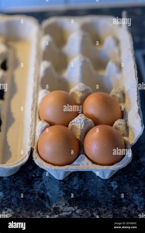 Cardboard Carton Retail Packaging With Four Fresh Brown Hens Eggs In A