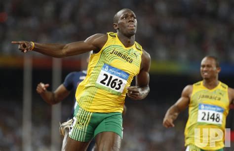 Runners race for 100m down the home straight of a 400m track. 100m World Record by Usain Bolt at 2008 Olympics in ...