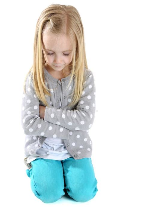 Cute Girl Kneeling Down Arms Folded Eyes Closed To Pray Stock Photo