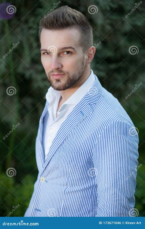 Portrait Of Young Elegant Handsome Man Posing Outside Stock Photo