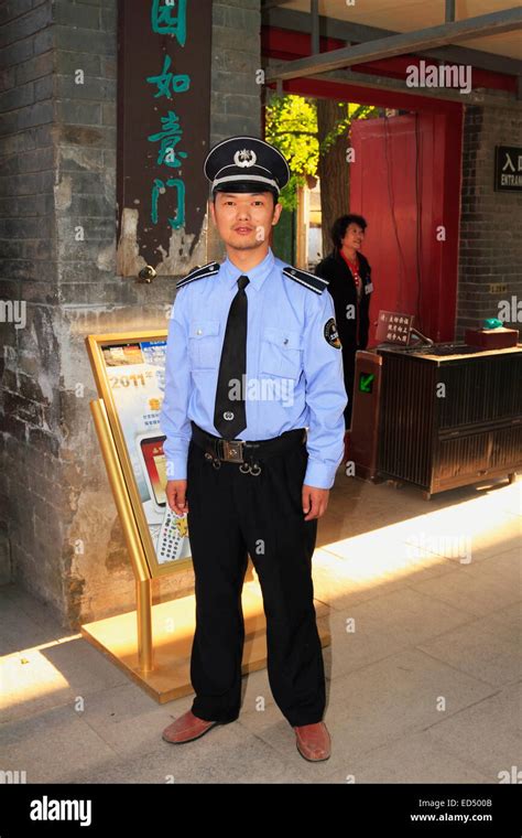 Chinese Officer Security Guard Or Policeman Wearing Uniform Looking At