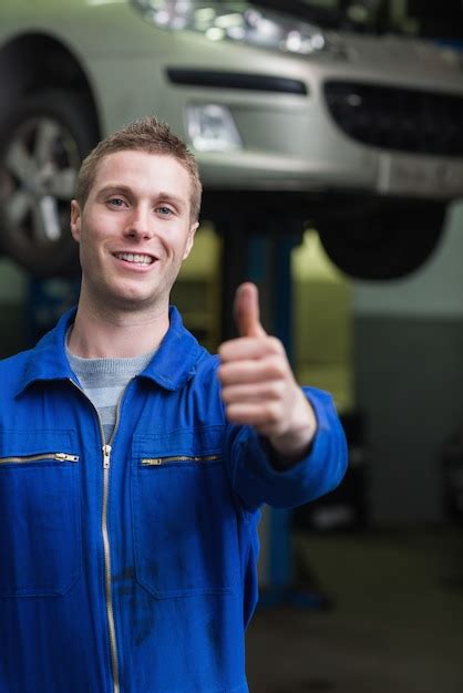 Premium Photo Happy Car Mechanic Gesturing Thumbs Up