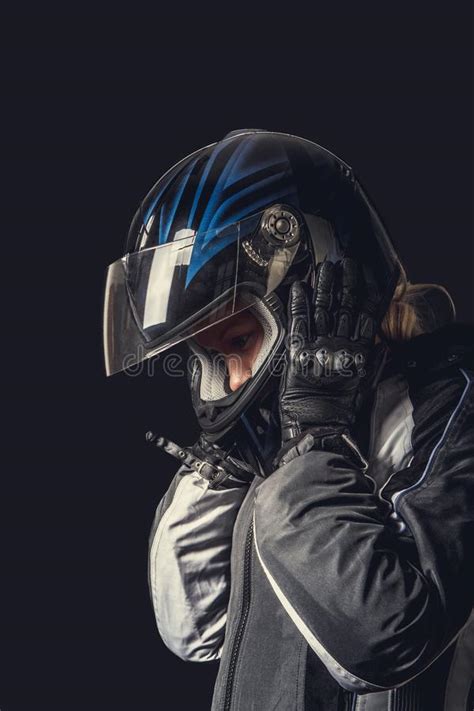 Female In Motorcycle Safety Costume And Black Helmet Stock Photo