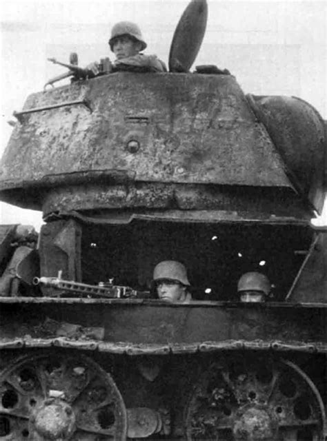 A German Mg42 Squad Uses A Knocked Out Soviet T 34 Tank As An