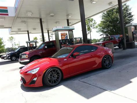 A Lowered Red Toyota 86 With Some Big Black Alloys At A 7 Eleventhey