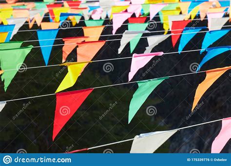 Many Multi Colored Triangular Flags Hanging On The Ropes As A Holiday