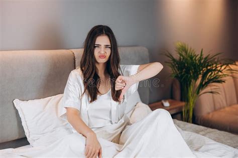 Female Model In White Silk Pajamas Showing Dislike Beautiful Woman