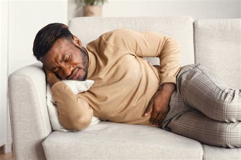 Young Man Suffering From A Bad Stomach Ache Pain Stock Photo Image Of