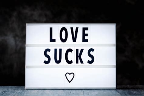 Text Love Sucks In A Lightbox Stock Photo Download Image