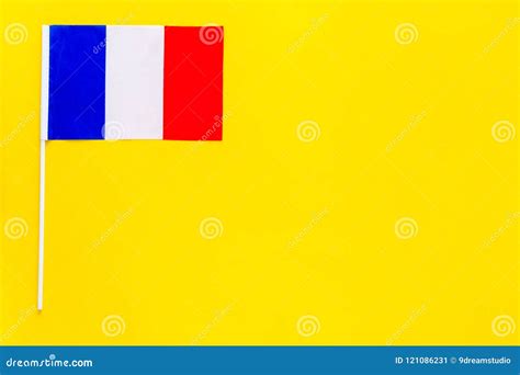 French Flag Concept Small Flag On Yellow Background Top View Copy