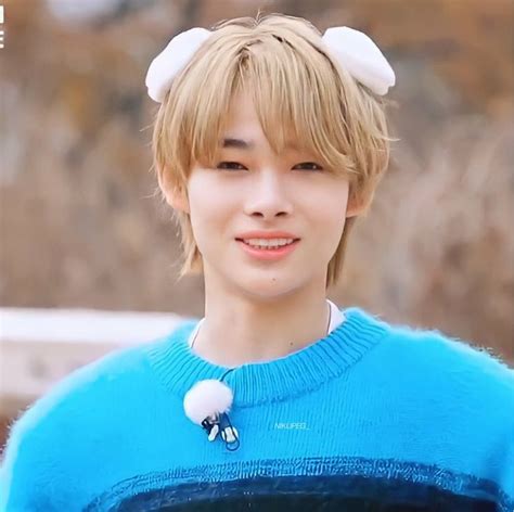 A Young Man With Blonde Hair Wearing A Blue Sweater And White Cat Ears