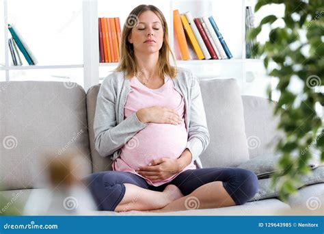 Beautiful Pregnant Woman Relaxing On The Sofa At Home Stock Image