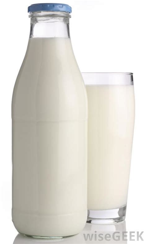 Glass cup and bottle full of milk, on wooden table. What Are the Different Types of Gluten-Free Milk?