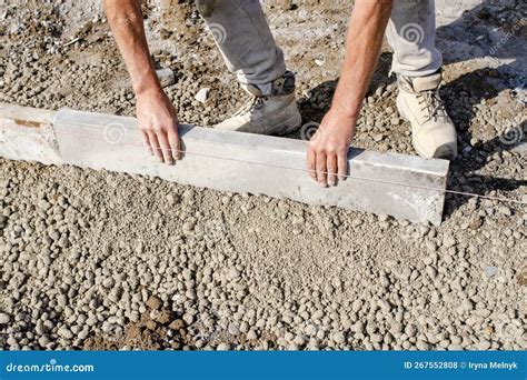 Groundworker Making Shutter For Concrete To Form A Base For Kerb Using