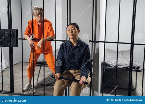 A Normal Day In A Women`s Prison A Female Warden Is On Guard For A Female Criminal Stock Image