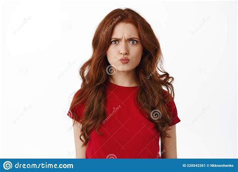 Confused And Angry Redhead Girl Pouting Frowning And Grimacing