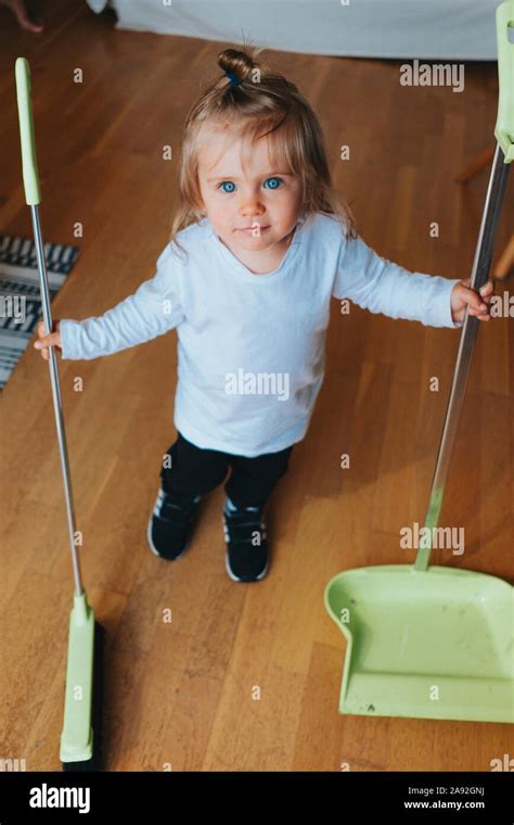 Girl Holding Dustpan And Brush Stock Photo Alamy