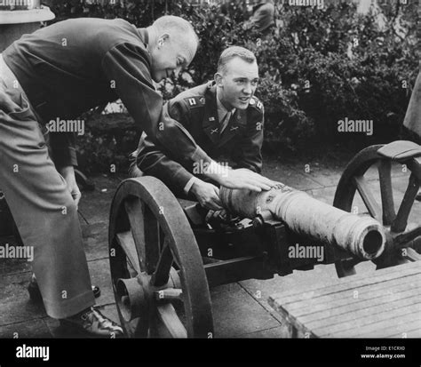 General Dwight Eisenhower And His Son John Look Over A Cannon At