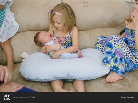 Little Girl Holding Newborn Baby Stock Photo Offset