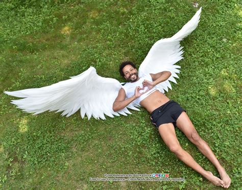 Winged Man Lying On The Ground With Heart Hands From High Perspective