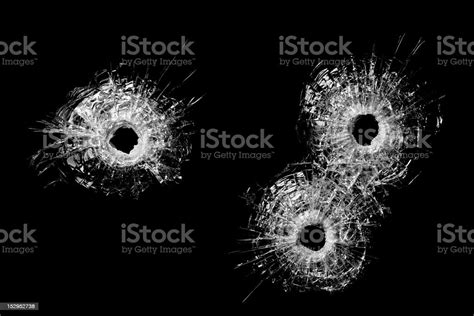Bullet Holes In Glass Isolated On Black Stock Photo Download Image