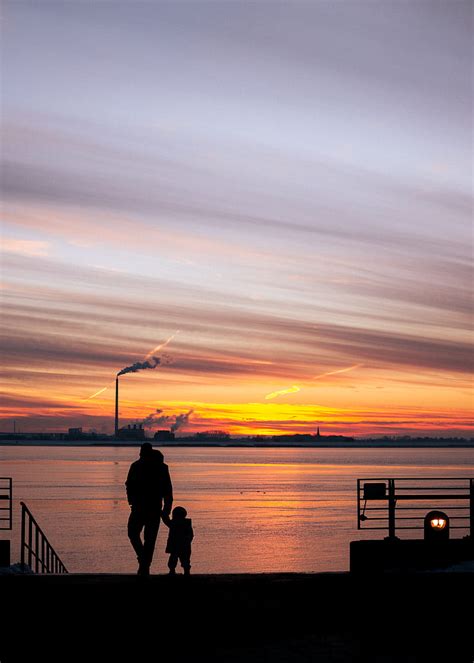 Silhouette Of Man And Woman Standing On Dock During Sunset Hd Phone