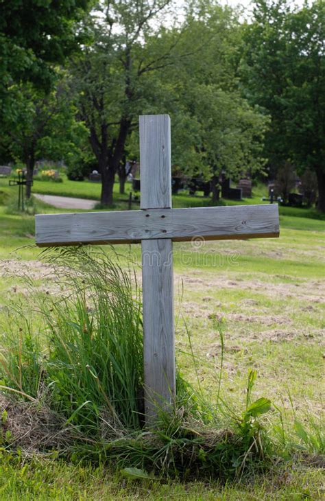 Burial tomb cross carved on a pumpkin for. Single Wood Cross In A Cemetery Stock Photo - Image of ...
