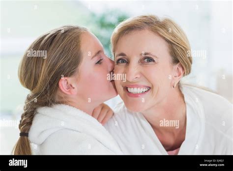 Pretty Little Girl Kissing Her Mother On Cheek Stock Photo Alamy