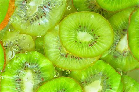 Kiwi Fruit Close Up In Liquid With Bubbles Slices Of Green Ripe Kiwi