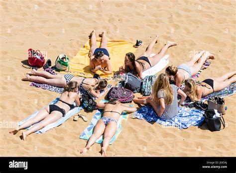 Eight Teenage Girls In Bikinis Laying In Circle On Beach Towels At Broadstairs Main Beach During