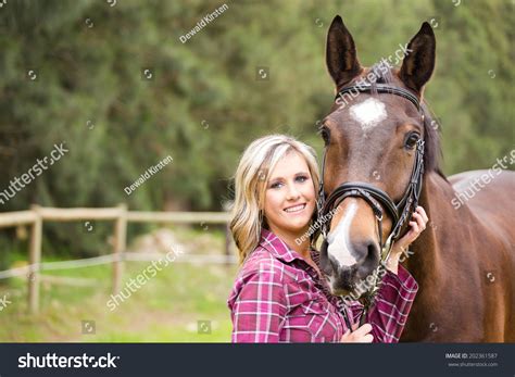 Sexy Blond Farm Girl Posing With Her Horse On A Farm In South Africa