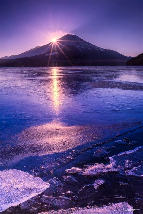 The Sun Shines Brightly Over An Icy Lake